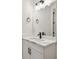 Modern bathroom featuring a vanity with marble countertop, matte black hardware, and vanity lighting at 301 S Daniels St, Plant City, FL 33563