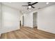 Open bedroom with wood-look flooring and neutral walls at 301 S Daniels St, Plant City, FL 33563
