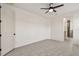 Neutral bedroom has tiled floors and a modern ceiling fan, creating a serene living space at 301 S Daniels St, Plant City, FL 33563