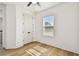 Bright bedroom with a ceiling fan, light wood floors, large window and a closet with double doors at 301 S Daniels St, Plant City, FL 33563