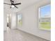 Bedroom with ceiling fan, tile floors and two large windows with views of the backyard at 301 S Daniels St, Plant City, FL 33563