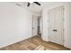 Bedroom with light wood floors, a ceiling fan and closet with double doors at 301 S Daniels St, Plant City, FL 33563