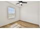 Clean and bright bedroom with hardwood floors, large windows and white walls at 301 S Daniels St, Plant City, FL 33563
