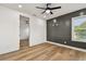 Bedroom featuring a dark accent wall, window, and wood-look floors at 301 S Daniels St, Plant City, FL 33563
