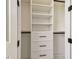 Detail of bedroom closet with white shelving and drawers, providing organized storage space at 301 S Daniels St, Plant City, FL 33563