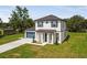 Beautiful two-story home with blue shutters, attached two car garage and a well manicured lawn at 301 S Daniels St, Plant City, FL 33563