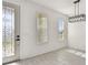 Bright, neutral entryway with tile flooring, a decorative door, and a modern light fixture at 301 S Daniels St, Plant City, FL 33563