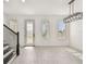 Beautiful entryway with light gray tile flooring, staircase, and modern lighting fixture at 301 S Daniels St, Plant City, FL 33563