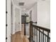 Modern hallway featuring wood floors and an entry to the bedroom with black accents at 301 S Daniels St, Plant City, FL 33563