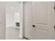 Hallway view showing a doorway, tile floors and a view of the kitchen and entry to the bedroom at 301 S Daniels St, Plant City, FL 33563