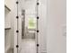 Bathroom and closet area features wood-look tile flooring, white walls, and bright lighting at 301 S Daniels St, Plant City, FL 33563