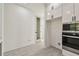 Modern kitchen with white cabinets, stainless appliances, and gray tile floors at 301 S Daniels St, Plant City, FL 33563