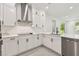 A modern kitchen with stainless steel appliances, white cabinets, and gray countertops at 301 S Daniels St, Plant City, FL 33563