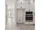 View of a modern kitchen with white cabinets, black hardware and gray tile flooring at 301 S Daniels St, Plant City, FL 33563