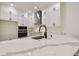 Bright white kitchen featuring quartz countertops, modern stainless steel appliances, and matte black hardware at 301 S Daniels St, Plant City, FL 33563