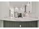 Stylish white kitchen featuring quartz countertops, stainless steel appliances, and a view to the living area at 301 S Daniels St, Plant City, FL 33563