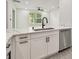 Modern kitchen with white cabinetry, gray counter tops, and stainless steel appliances at 301 S Daniels St, Plant City, FL 33563