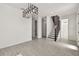 Open living space with gray tile flooring, staircase, and modern lighting at 301 S Daniels St, Plant City, FL 33563