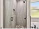 Modern shower featuring sleek gray tiling and frameless glass door plus shower niche at 301 S Daniels St, Plant City, FL 33563