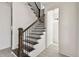 Staircase with black railings, wooden posts, and gray tile flooring at 301 S Daniels St, Plant City, FL 33563