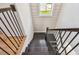 Elegant stairway with dark wood treads, contrasting railings, and bright window views at 301 S Daniels St, Plant City, FL 33563