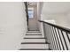 Stylish stairway with dark wood treads, black metal railing, and a bright window at 301 S Daniels St, Plant City, FL 33563