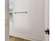 Bright wall with a window, blinders, black towel rack, white trim, and light wood floors at 301 S Daniels St, Plant City, FL 33563