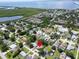Breathtaking aerial view of a home in a community surrounded by water and lush landscaping at 3115 Bay Ln, Clearwater, FL 33759