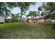 Spacious backyard featuring lush greenery and a cozy patio area, perfect for outdoor relaxation and entertaining at 3115 Bay Ln, Clearwater, FL 33759