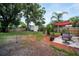 Landscaped backyard featuring a patio area with seating, a storage shed, and a well-maintained lawn with a wooden fence at 3115 Bay Ln, Clearwater, FL 33759