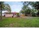 Spacious backyard with a patio, garden beds, privacy fence, and mature trees at 3115 Bay Ln, Clearwater, FL 33759