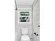 This bathroom features a window and toilet at 3115 Bay Ln, Clearwater, FL 33759