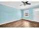 This bedroom features hardwood floors, a ceiling fan and natural light at 3115 Bay Ln, Clearwater, FL 33759