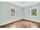 This bedroom features hardwood floors, two windows and fresh paint at 3115 Bay Ln, Clearwater, FL 33759