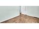 Bright bedroom featuring hardwood floors and a white door at 3115 Bay Ln, Clearwater, FL 33759