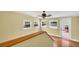 Bright bonus room with hardwood floors, ceiling fan, and multiple windows offering natural light at 3115 Bay Ln, Clearwater, FL 33759