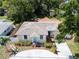 Aerial view of a well-kept single-story home with charming front yard, complemented by a circular driveway at 3115 Bay Ln, Clearwater, FL 33759