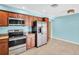This kitchen features stainless steel appliances and wood cabinets at 3115 Bay Ln, Clearwater, FL 33759