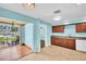 This kitchen features stone countertops, wood cabinets and a sliding door at 3115 Bay Ln, Clearwater, FL 33759