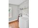Laundry room with washer, dryer, and overhead shelving for storage at 3115 Bay Ln, Clearwater, FL 33759