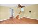 Open living room with ceiling fan and hardwood floors that create a warm and inviting space at 3115 Bay Ln, Clearwater, FL 33759