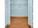 Walk-in closet with shelving and hardwood floors, perfect for organization and storage at 3115 Bay Ln, Clearwater, FL 33759