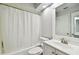 Bright bathroom featuring a shower/tub combo with white tile and a matching vanity at 3308 W Wyoming Cir, Tampa, FL 33611