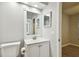 A bathroom features a vanity with storage and bright lighting at 3308 W Wyoming Cir, Tampa, FL 33611