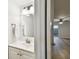 Bathroom with a sink, mirror, and towel bar, with view to the living room at 3308 W Wyoming Cir, Tampa, FL 33611