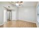 This bedroom offers wood-look flooring, a ceiling fan, and neutral paint at 3308 W Wyoming Cir, Tampa, FL 33611