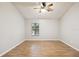 Spacious bedroom with wood-look flooring and a ceiling fan at 3308 W Wyoming Cir, Tampa, FL 33611
