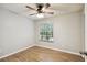 Bright bedroom featuring wood-look flooring and a ceiling fan at 3308 W Wyoming Cir, Tampa, FL 33611