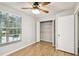 This bedroom features an open closet and wood-look flooring at 3308 W Wyoming Cir, Tampa, FL 33611