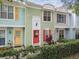 Eye-catching townhouses boast vibrant, unique doors and shutters enhanced by lush landscaping for curb appeal at 3308 W Wyoming Cir, Tampa, FL 33611